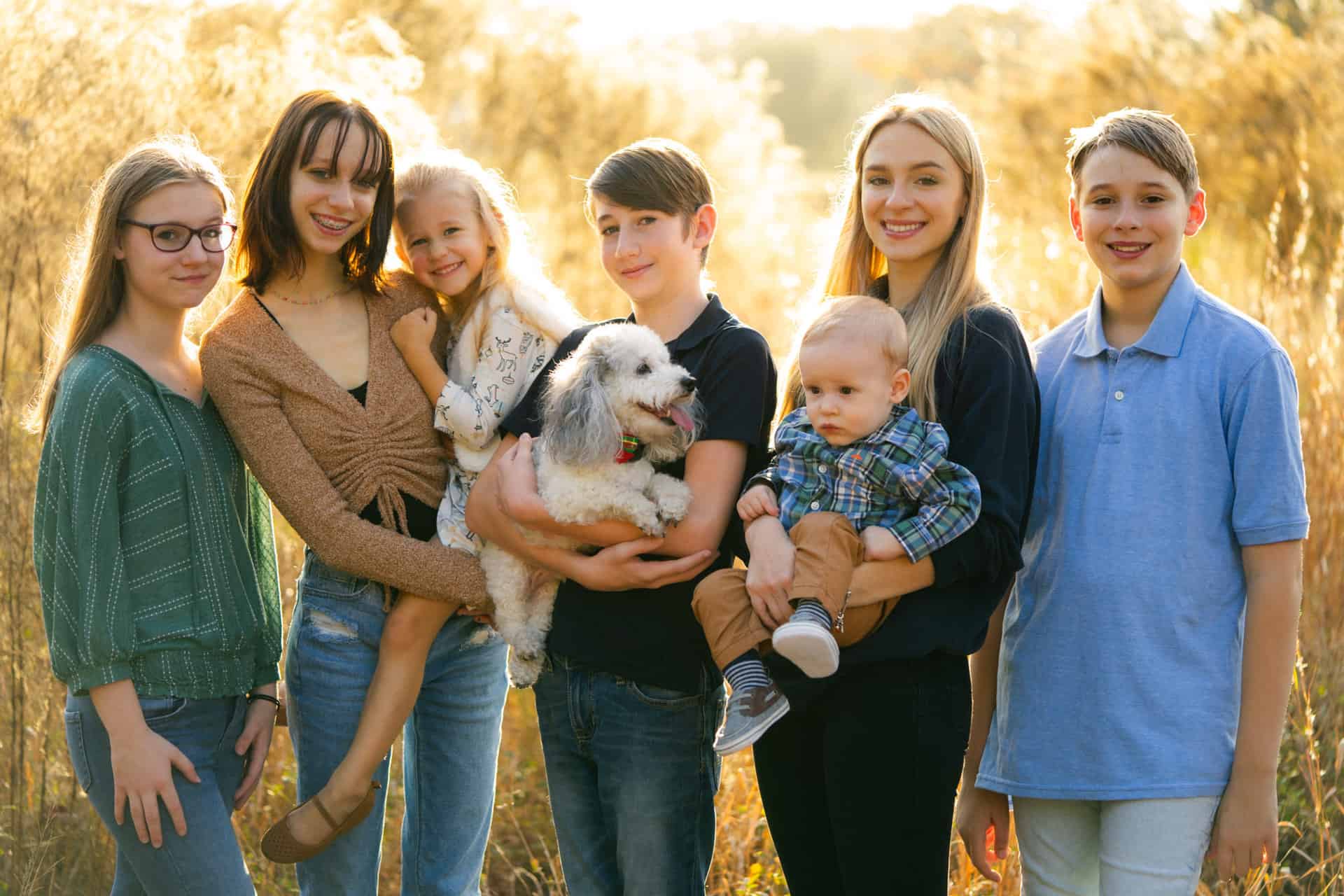 Family with dog enjoying outdoor autumn scenery at Camp Milton.