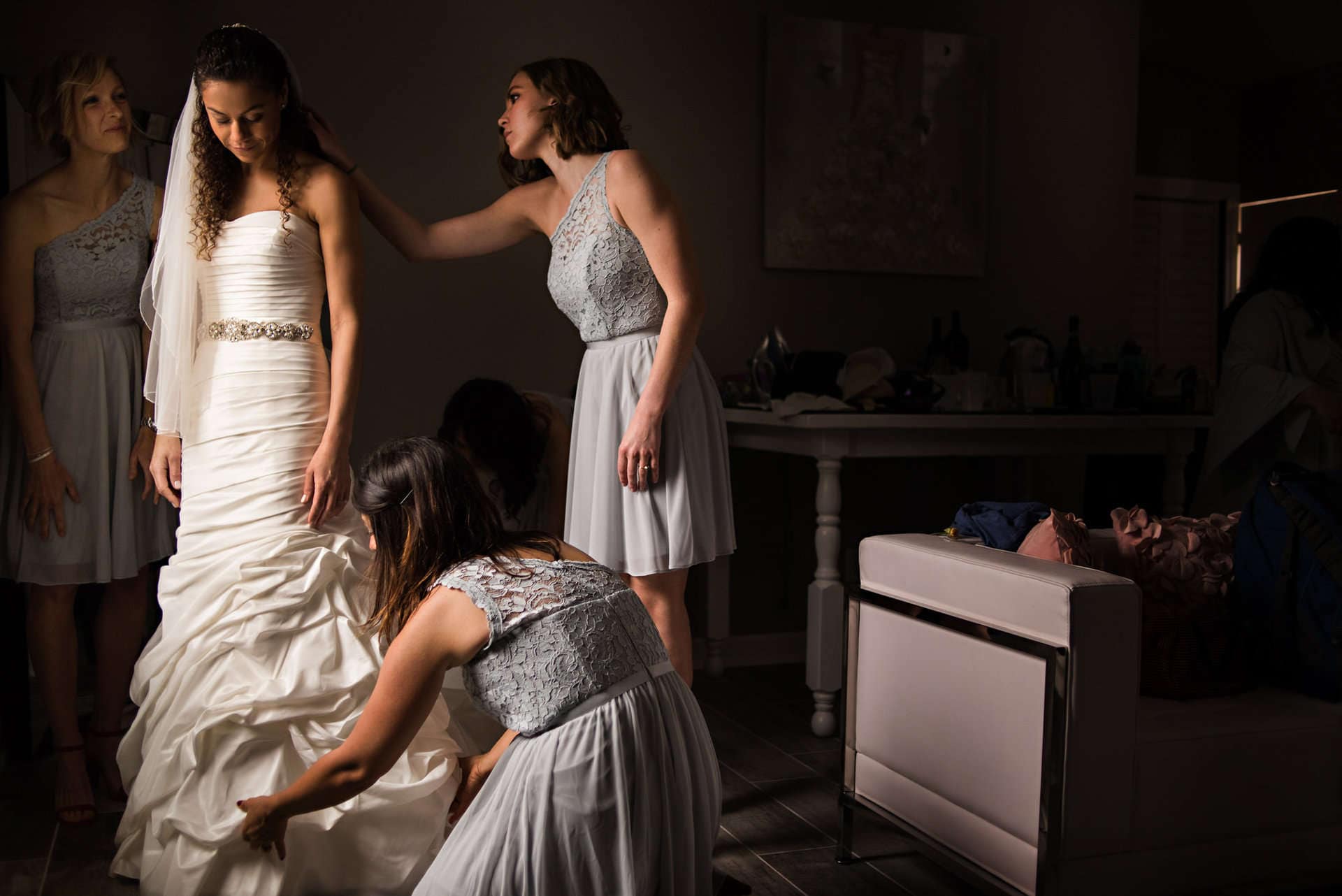 Women in elegant dresses during wedding dress fitting at Chris David Photography.