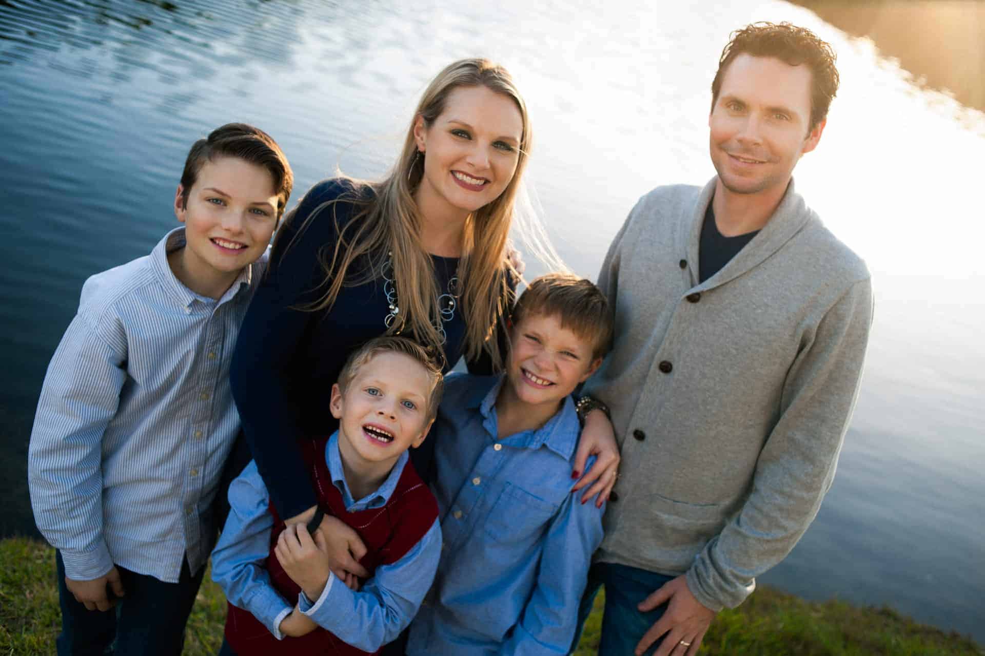 Family enjoying outdoor photo session by the water.