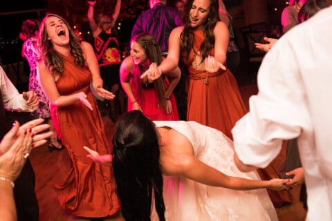 Bride and bridesmaids dance at wedding reception
