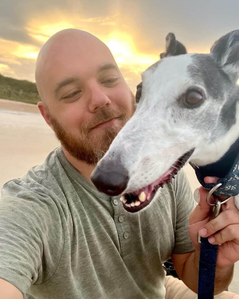 Man and greyhound on the beach
