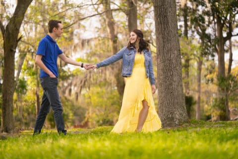 Man and woman hold hands and walk together in a park
