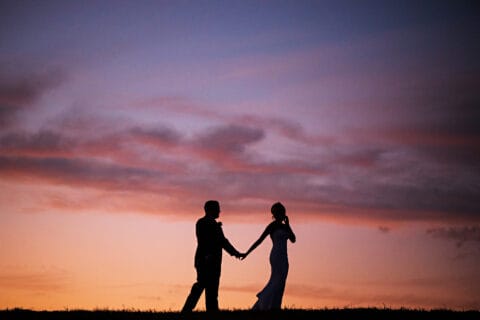 Silhouette of bride and groom at sunset