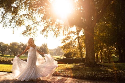 Bride twirls her dress during sunset